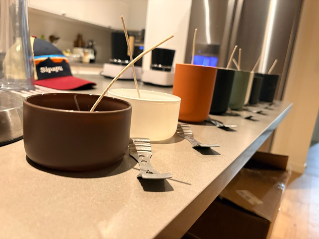 Wicks braced across Hartisans vessels on the kitchen counter